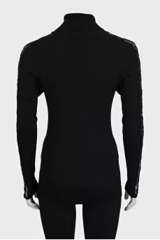 Black turtleneck with lace inserts on the sleeves