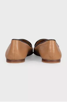 Brown leather ballet flats with black toe