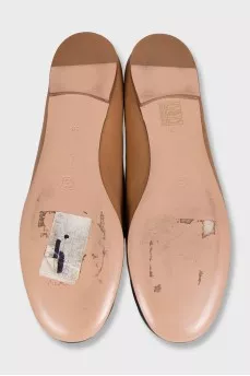 Brown leather ballet flats with black toe