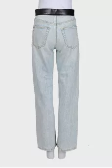 Light blue straight-leg jeans with a black belt