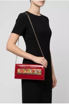 Red leather clutch decorated with enamel