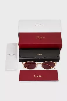 Sunglasses with purple lenses and gold frames