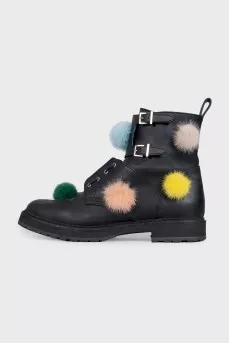 Black leather boots decorated with pom-poms