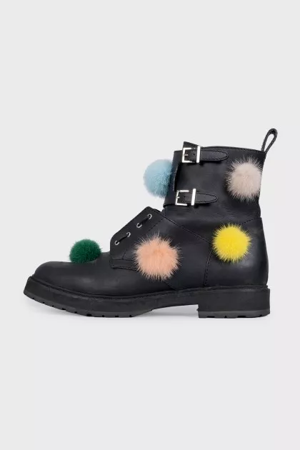 Black leather boots decorated with pom-poms