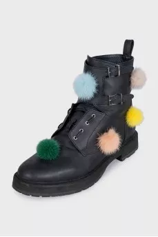 Black leather boots decorated with pom-poms