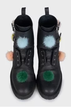 Black leather boots decorated with pom-poms