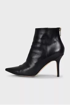 Black leather ankle boots with a gold zipper