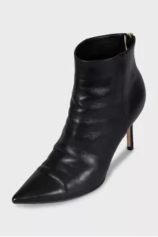 Black leather ankle boots with a gold zipper