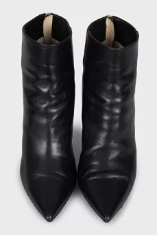 Black leather ankle boots with a gold zipper