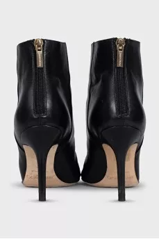 Black leather ankle boots with a gold zipper