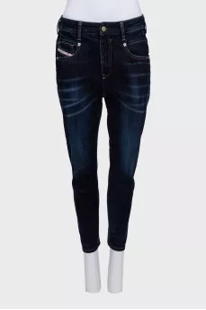 Dark blue tapered fit jeans with a distressed effect