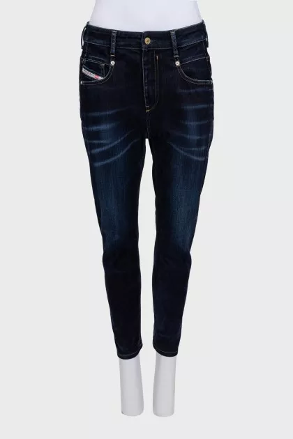 Dark blue tapered fit jeans with a distressed effect