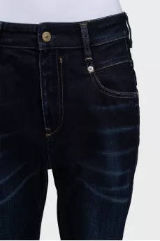 Dark blue tapered fit jeans with a distressed effect