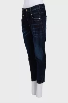 Dark blue tapered fit jeans with a distressed effect
