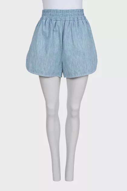 Light blue shorts with elastic waistband and pockets
