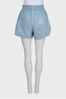Light blue shorts with elastic waistband and pockets