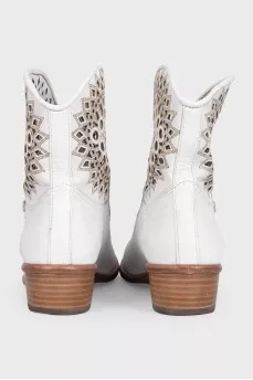 White leather Cossack boots decorated with perforations