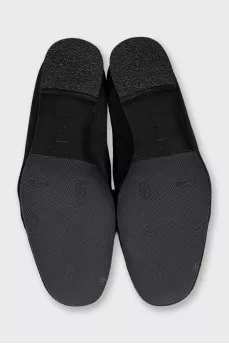 Black suede loafers with gold trim