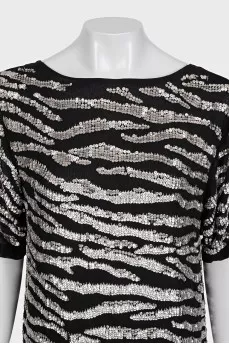 A loose-fitting black dress decorated with sequins