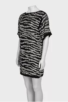 A loose-fitting black dress decorated with sequins