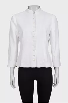 The white jacket is decorated with embroidery
