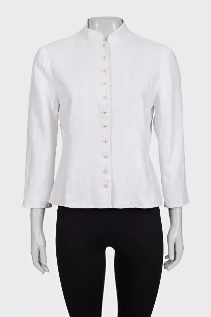 The white jacket is decorated with embroidery