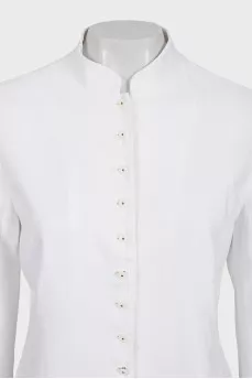The white jacket is decorated with embroidery