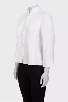The white jacket is decorated with embroidery