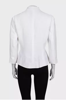 The white jacket is decorated with embroidery