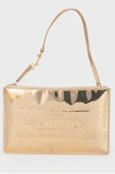 Golden clutch from a brand's logo
