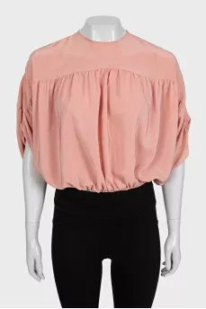 Cropped silk blouse with a button