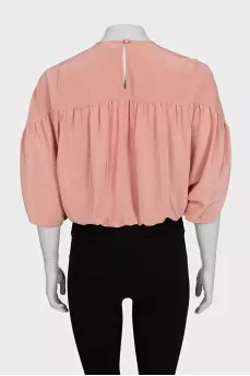 Cropped silk blouse with a button