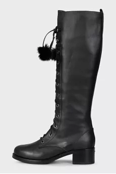 Black leather boots decorated with pom-poms