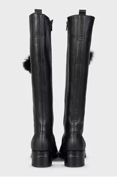 Black leather boots decorated with pom-poms
