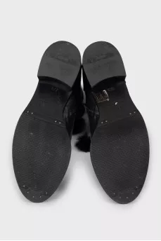 Black leather boots decorated with pom-poms
