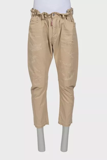 Men's beige trousers with abrasions