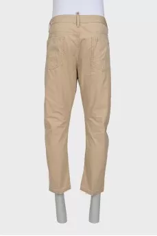 Men's beige trousers with abrasions