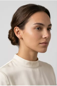 Gold earrings in the shape of spheres