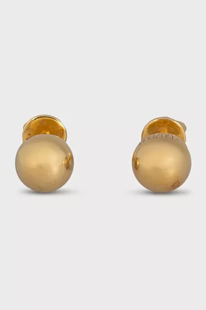 Gold earrings in the shape of spheres