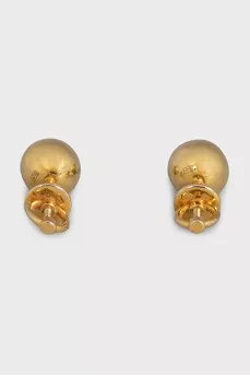 Gold earrings in the shape of spheres