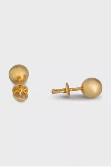 Gold earrings in the shape of spheres