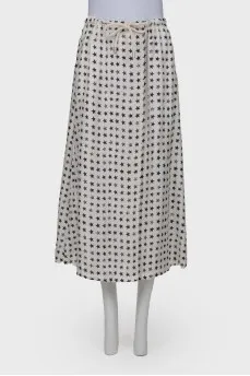 White skirt embellished with black stars, laced up