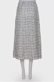 White skirt embellished with black stars, laced up