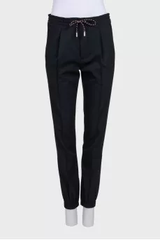 Men's black tapered trousers with zippers at the bottom