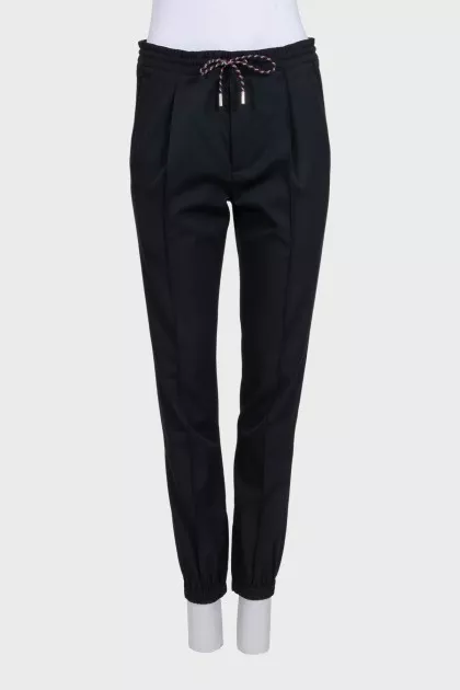 Men's black tapered trousers with zippers at the bottom