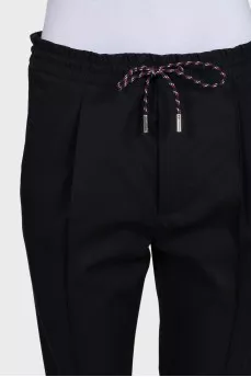 Men's black tapered trousers with zippers at the bottom