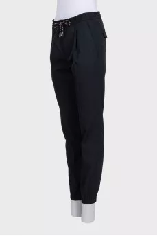 Men's black tapered trousers with zippers at the bottom
