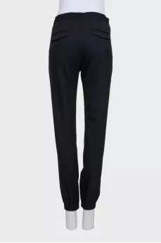 Men's black tapered trousers with zippers at the bottom