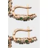 Gold earrings decorated with emeralds