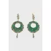 Gold earrings decorated with emeralds